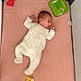 Lyana a rejoint le concours — aidez-le/la à gagner de superbes lots ! baby, infant, onesie, crib, playpen, toy, plush_doll, giraffe_teether, pink_mattress, child, sleepwear, cute, small, indoor, resting, looking_sideways, fabric, soft, newborn, bed