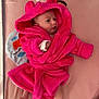 baby, infant, pink_robe, hood, soft_toy, blanket, mattress, bed, cute, child, newborn, lying_down, clothing, indoors, toy, colorful, expression, face, hand, foot
