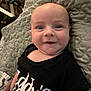 Gabriel is registered to the contest to win money with this photo: baby, black_shirt, blanket, child, cute, expression, eyes, face, furniture, happy, head, indoor, infant, mouth, person, portrait, quilted, skin, smiling, text_on_clothing