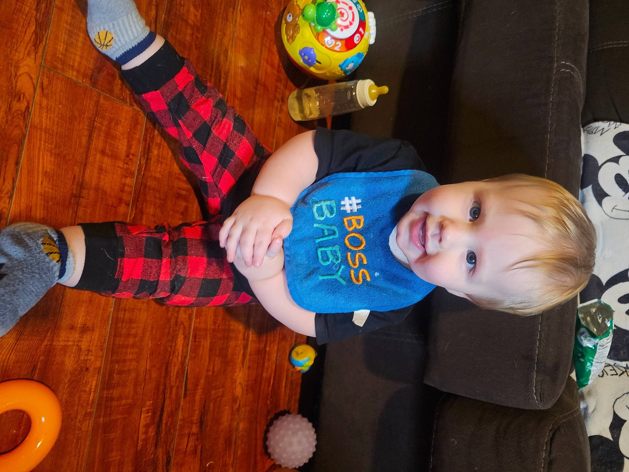 Gavin is registered to the contest to win money with this photo: baby, baby_toddler_clothing, baby_toys, child, event, fun, hardwood, orange, pattern, people, person, plaid, play, smile, sock, tartan, textile, toddler, toy, wood