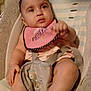 Ka'Lia joined the competition — help win amazing prizes! baby, infant, child, pink_bib, baby_chair, cushion, harness, seated, curious_expression, soft_fabric, indoor, clothing, foot, hand, face, looking_away, striped_background, cute, young, portrait