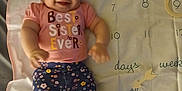 Ka'Lia is registered to the contest to win money with this photo: baby, smiling, infant, milestone_blanket, pink_shirt, floral_leggings, numbers, text, lying_down, cute, child, happy, portrait, feet, arms, indoor, fabric, calendar, months, person