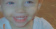 Cheryl is registered to the contest to win money with this photo: toddler, child, smiling, blue_eyes, light_hair, white_shirt, fish_prints, dirt_stain, indoor, portrait, happy, cute, young_child, timestamp, vintage_style, closeup, person, face, casual, playful