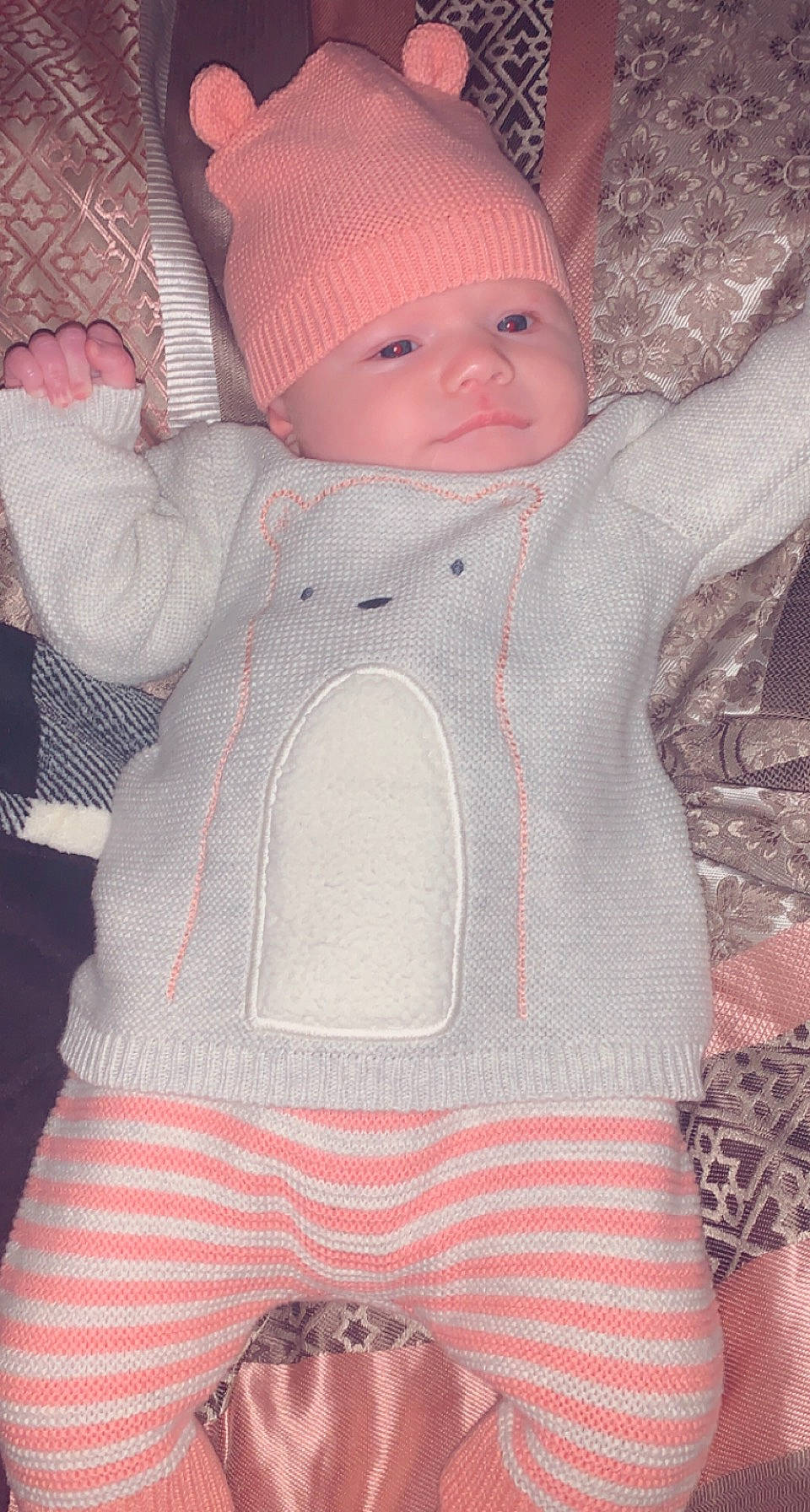 Bellarae is registered to the contest to win money with this photo: baby, baby_toddler_clothing, cap, cheek, eye, face, grey, head, headwear, human_body, jacket, knit_cap, outerwear, pattern, person, pink, skin, sleeve, textile, toddler