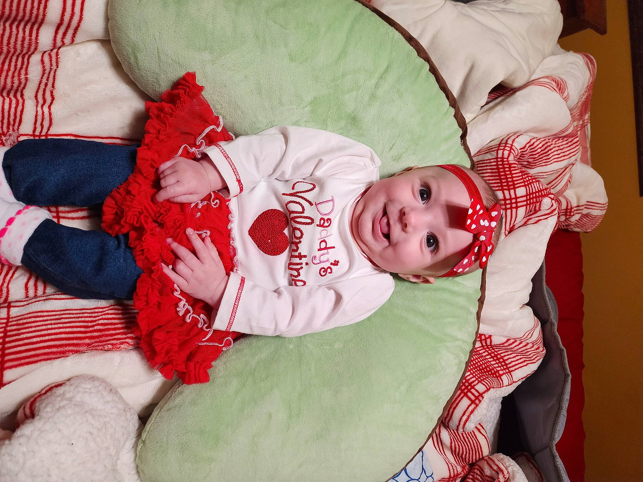 Dakota is registered to the contest to win money with this photo: baby, baby_products, baby_toddler_clothing, carmine, child, christmas, christmas_eve, comfort, event, fictional_character, fur, happy, headwear, joy, lap, linens, nightwear, pattern, person, room