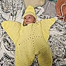Xavier joined the competition — help win amazing prizes! baby, infant, crocheted_costume, yellow, starfish, blanket, patterned, lying_down, headwear, cozy, soft_texture, indoor, cute, face, child, knitted, wearing, resting, person, young