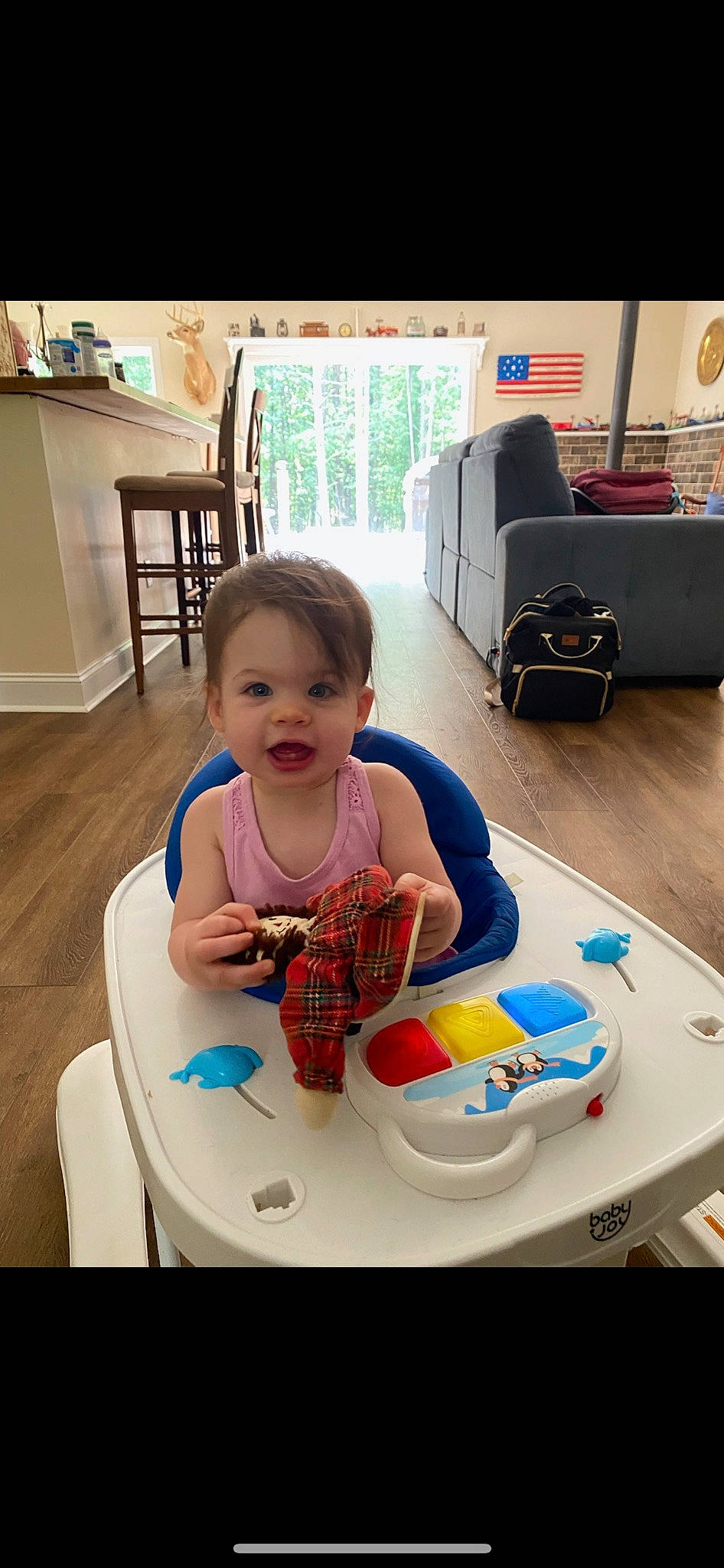 Lillyan is registered to the contest to win money with this photo: automotive_design, baby, baby_toddler_clothing, chair, child, floor, flooring, fun, happy, leisure, motor_vehicle, person, play, room, sitting, smile, t_shirt, table, tire, toddler