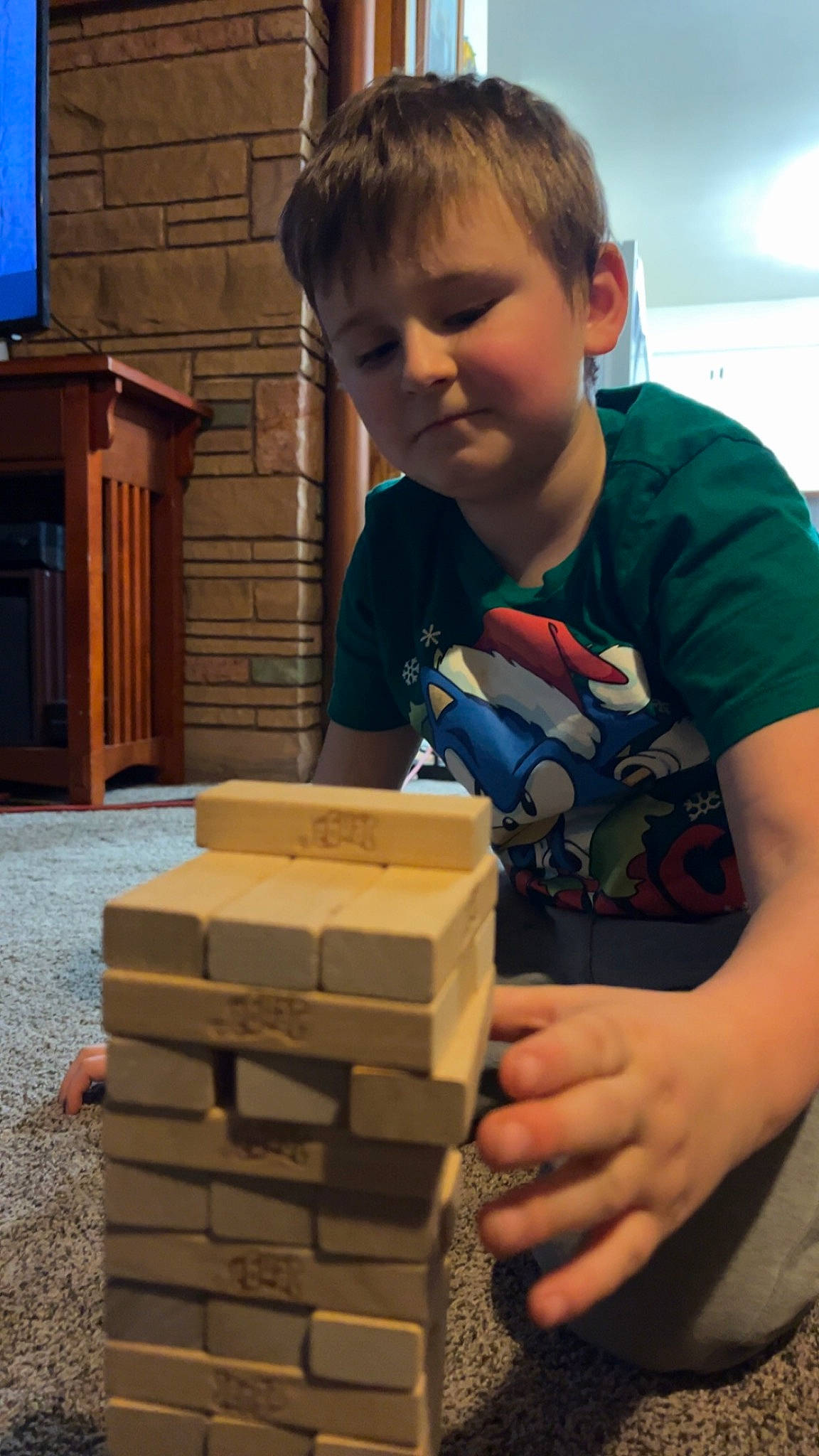 Zayden joined the competition — help win amazing prizes! box, cardboard, child, curious, flooring, fun, hairstyle, hardwood, machine, person, play, standing, t_shirt, television, thumb, toddler, toy, toy_block, wood, wood_stain