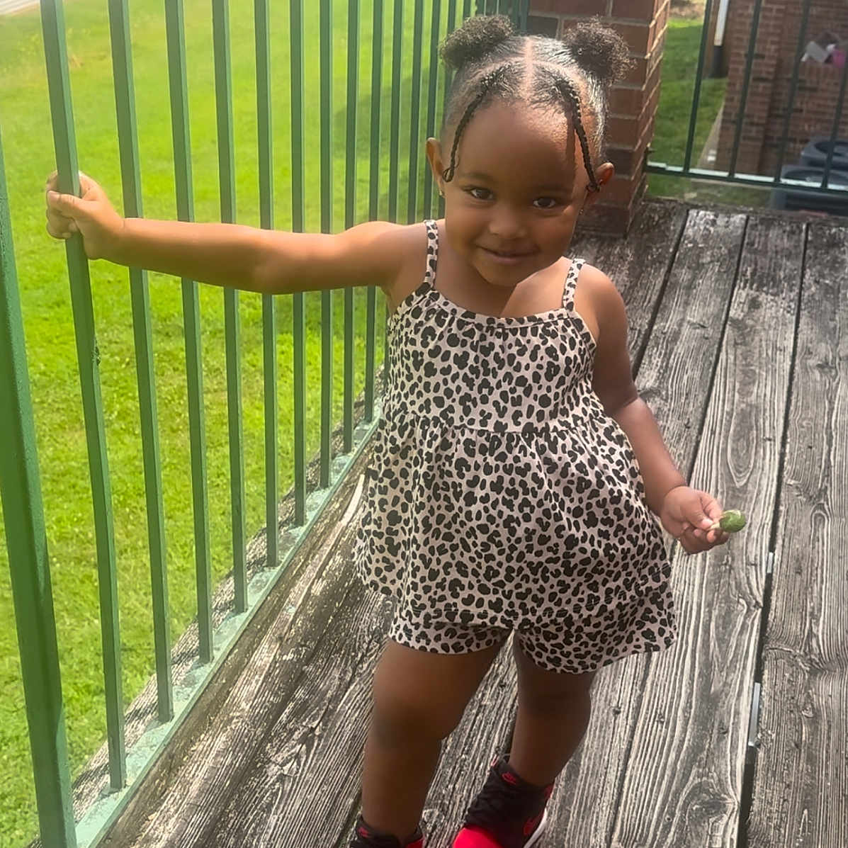 Audrey is registered to the contest to win money with this photo: backyard, child, clothing, dress, face, female, footwear, girl, grass, head, nature, outdoors, person, photography, plant, portrait, sandal, shoe, shorts, wood