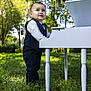 Moisés Iza Tamayo joined the competition — help win amazing prizes! toddler, child, boy, suit, bow_tie, piano, white_piano, outdoor, grass, sunlight, trees, nature, portrait, standing, curious, formal_wear, greenery, daylight, cute, smiling