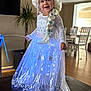 toddler, child, girl, costume, dress, wig, blonde_hair, braid, glowing, blue, indoor, living_room, table, smiling, happy, person, furniture, plant, chair, wood_floor