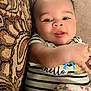 baby, infant, child, face, smiling, striped_clothing, hello_text, couch, pillow, blanket, floral_pattern, comfort, indoors, young_child, portrait, human, skin, cute, happy, relaxed