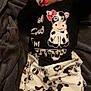 baby, infant, pacifier, headband, cow_print, black_clothing, white_clothing, blanket, lying_down, cute, cartoon_cow, patterned_pants, soft_fabric, child, indoors, smiling_cow, baby_clothes, sleepy, hand, comfort
