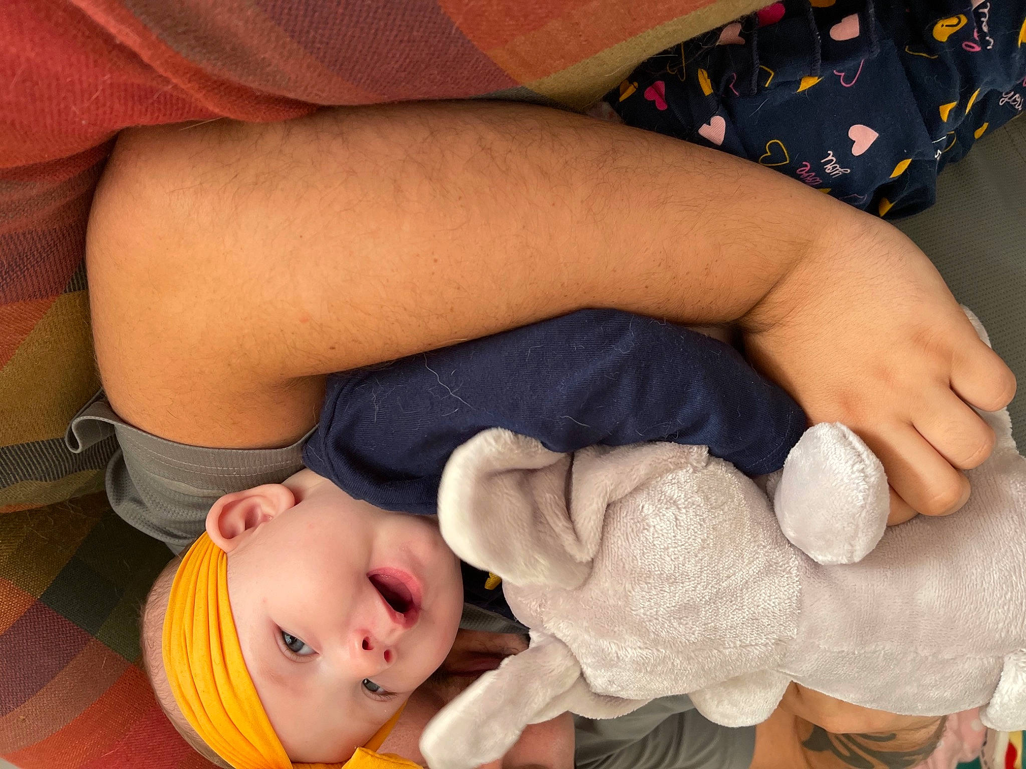 Harmonie is registered to the contest to win money with this photo: arm, blue, clothing, comfort, eye, face, finger, fun, hairstyle, head, headwear, human, leg, people, person, product, room, sitting, stuffed_toy, vertebrate