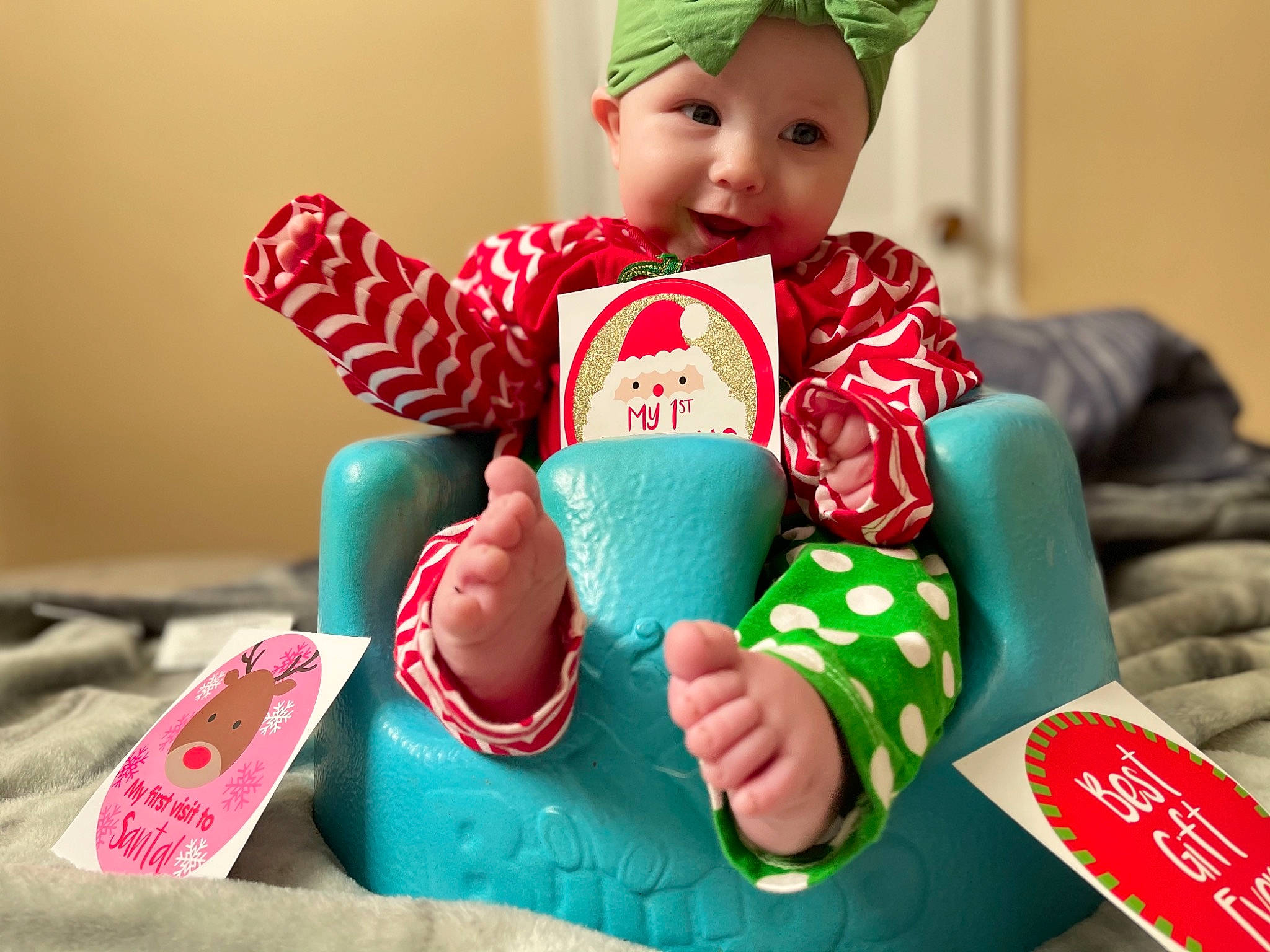 Harmonie is registered to the contest to win money with this photo: baby, baby_toddler_clothing, baby_toys, bonnet, finger, headband, headwear, nail, person, slipper, toddler, toy