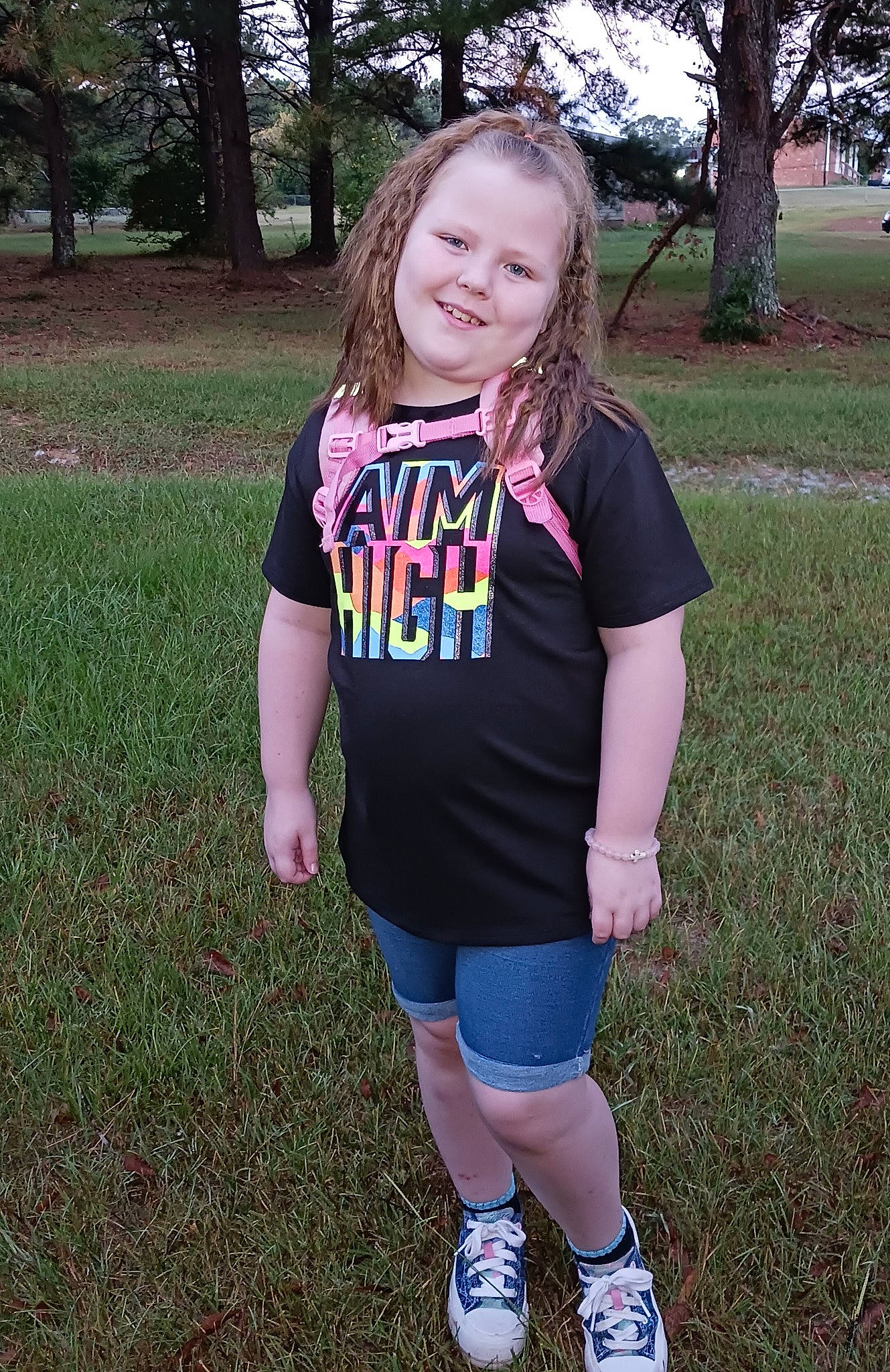 Alexis joined the competition — help win amazing prizes! arm, blond, electric_blue, fun, grass, hair, happy, jersey, joy, long_hair, outerwear, people_in_nature, person, pink, plant, shorts, sleeve, smile, sports_uniform, t_shirt