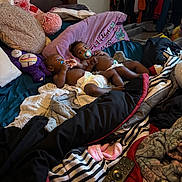 Jalen And David joined the competition — help win amazing prizes! baby, bed, blanket, clothing, diaper, face, furniture, pacifier, person, pillow, remote_control, room, stuffed_animal, toy, twin, lying_down, indoors, child, sleepwear, curly_hair