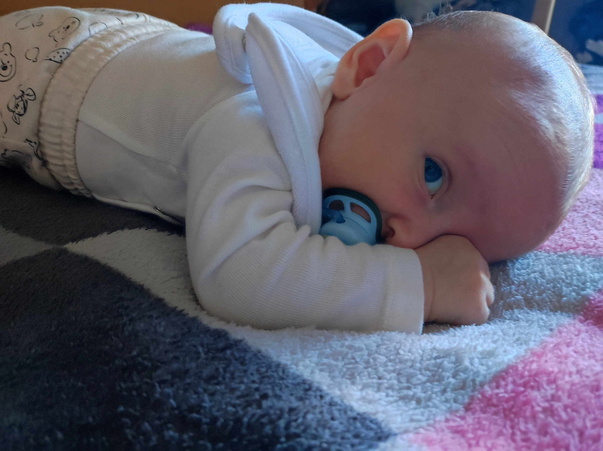 Mahé a rejoint le concours — aidez-le/la à gagner de superbes lots ! baby, infant, pacifier, blanket, white_clothing, lying_down, blue_eyes, close_up, cute, soft_texture, indoors, child, toddler, sleepy, cozy, skin, hand, head, portrait, comfort