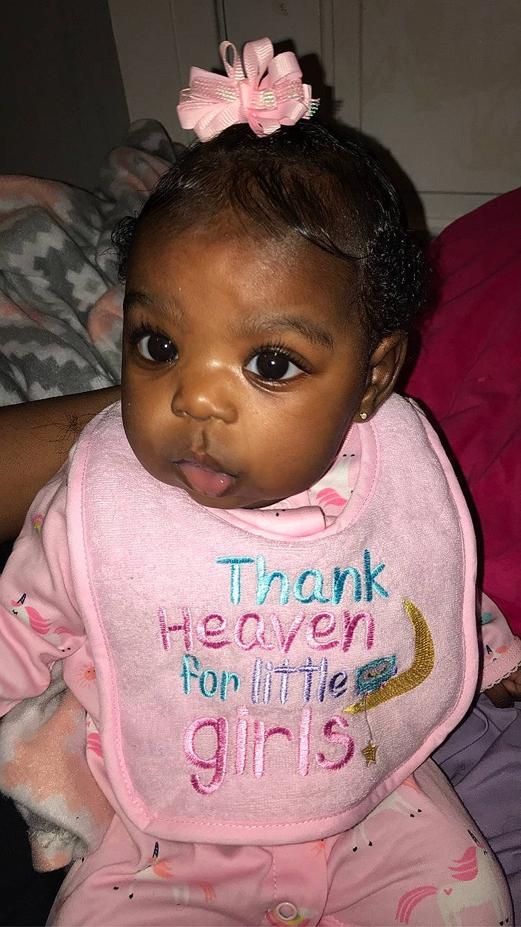 Brazil is registered to the contest to win money with this photo: baby, baby_toddler_clothing, cheek, child, chin, dress, eye, eyebrow, eyelash, forehead, hairstyle, happy, head, iris, lip, nose, person, pink, skin, toddler