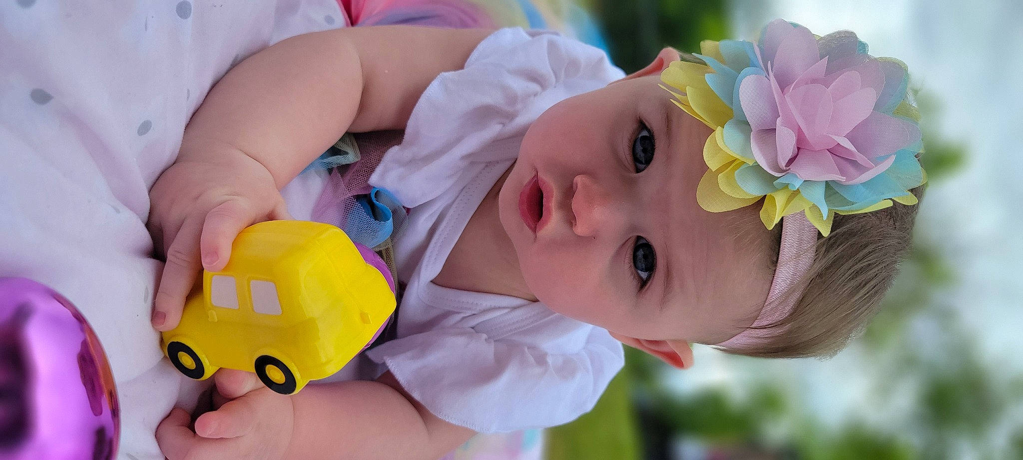 Carlee is registered to the contest to win money with this photo: baby, baby_products, baby_toddler_clothing, child, facial_expression, finger, flower, fun, grass, hand, happy, hat, headpiece, headwear, nose, person, petal, plant, product, skin