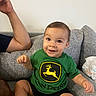 Zylan joined the competition — help win amazing prizes! arm, baby, casual, child, couch, cute, footwear, gray_couch, green_shirt, happy, home, indoor, john_deere, person, portrait, shorts, sitting, smiling, toddler, young_child