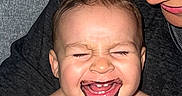 Zylan is registered to the contest to win money with this photo: adult, baby, child, chocolate, closeup, couch, expression, face, family, hair, happy, head, holding, indoor, joy, laughing, messy_face, person, skin, smiling