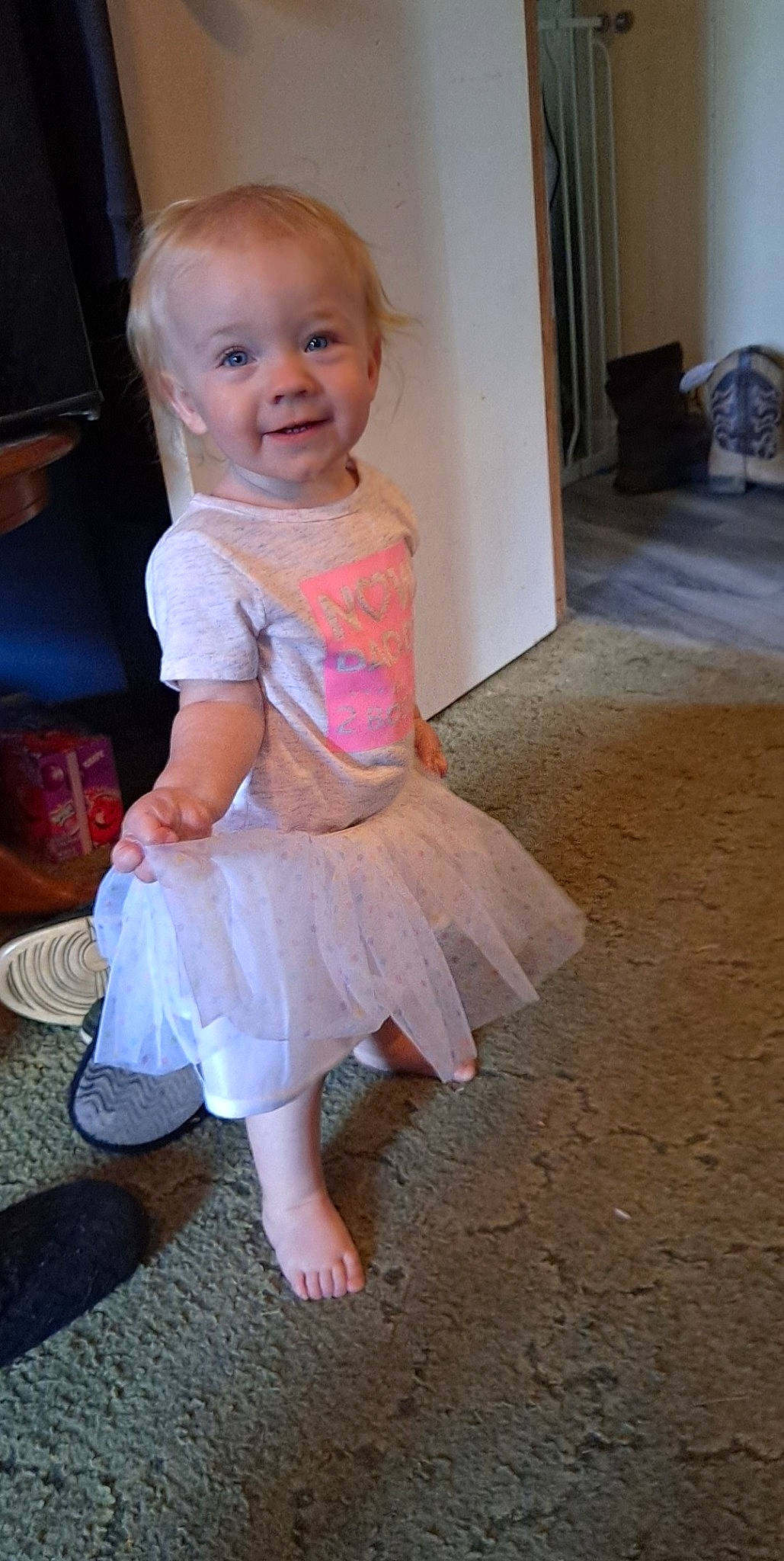 Evelynn is registered to the contest to win money with this photo: baby, baby_toddler_clothing, blond, cheek, child, day_dress, face, floor, flooring, foot, fun, human_leg, iris, joy, person, pink, sitting, skin, sleeve, smile