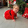 baby, celebration, child, christmas, christmas_tree, crawling, cute, decor, festive, floor, holiday, holiday_decorations, indoors, nutcracker, person, pigtails, red_dress, smiling, stocking, tiled_floor