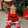 Marion a rejoint le concours — aidez-le/la à gagner de superbes lots ! baby, child, christmas, christmas_tree, cute, decorations, festive_clothing, floor, gift_bag, happy, holiday, indoors, nutcracker, portrait, red_dress, sitting, smiling, socks, striped_leggings, toy