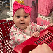 Presley joined the competition — help win amazing prizes! baby, child, shopping_cart, headband, pink_bow, clothing_store, clothes, rack, shopping, cute, infant, portrait, smiling, hand, retail, indoor, person, apparel, store, toddler