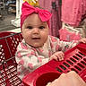 baby, child, shopping_cart, headband, pink_bow, clothing_store, clothes, rack, shopping, cute, infant, portrait, smiling, hand, retail, indoor, person, apparel, store, toddler