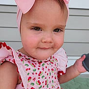 Averie is registered to the contest to win money with this photo: toddler, child, pink_bow, dress, cherry_pattern, drool, portrait, face, smile, outdoor, window, porch, headwear, cute, person, clothing, sleeveless, young_child, skin, expression