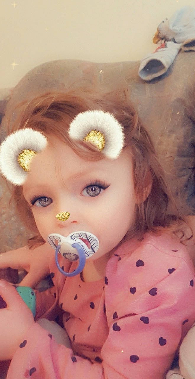 Amber is registered to the contest to win money with this photo: baby, brown_hair, cheek, child, doll, ear, eye, eyelash, face, fawn, head, iris, lip, mouth, nose, pink, skin, toddler, toy