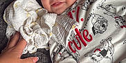 Hudson joined the competition — help win amazing prizes! baby, smiling, child, onesie, puppy_print, blanket, hand, cloth, leather_couch, cozy, infant, cute, blue_eyes, soft_texture, portrait, lying_down, happy, indoor, close_up, skin