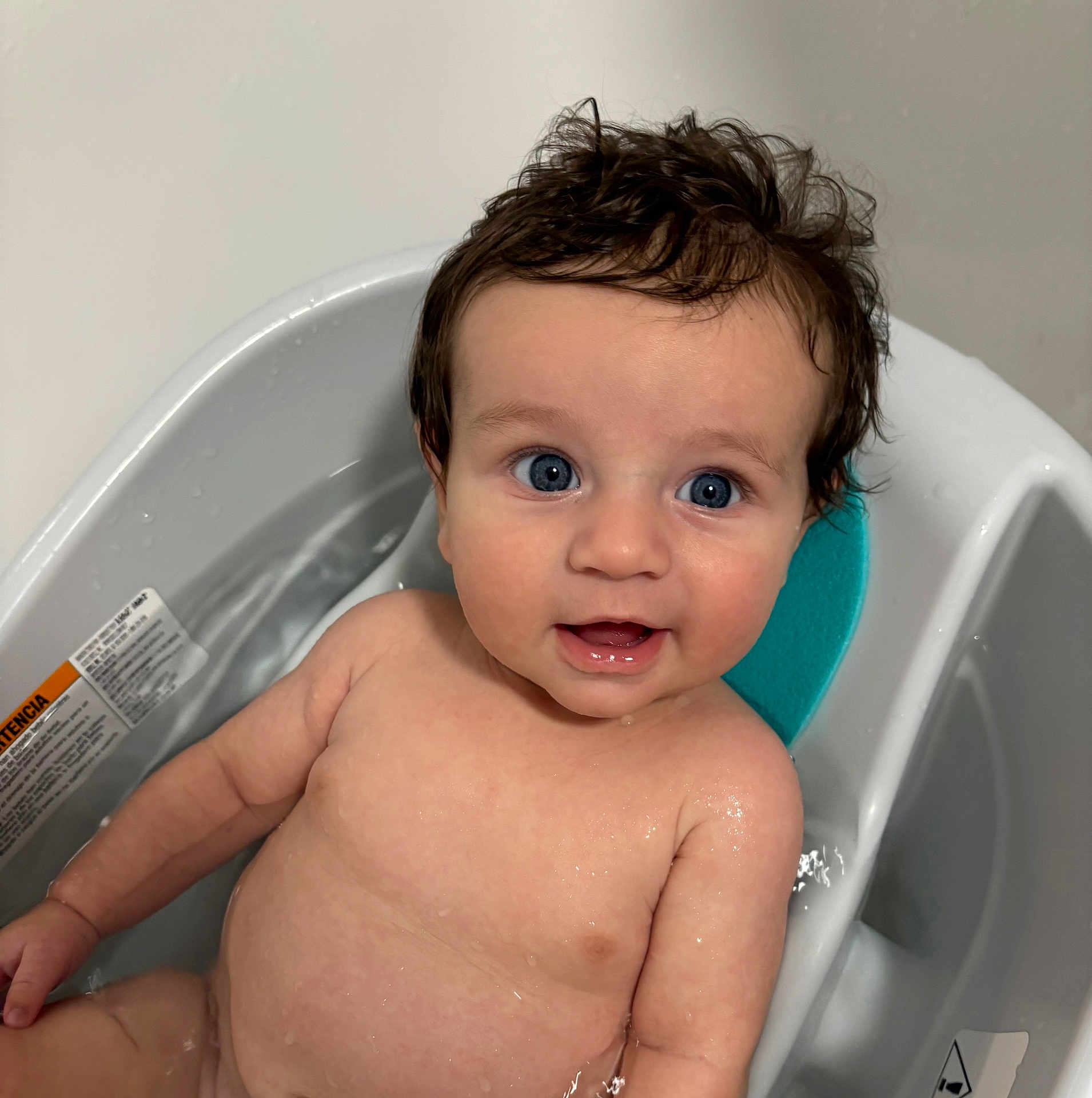 Hudson is registered to the contest to win money with this photo: baby, child, blue_eyes, bath, bathtub, water, wet_skin, happy, smiling, cute, infant, skin, head, hair, person, sitting, indoor, closeup, toddler, baby_bath