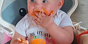 Ava Grace joined the competition — help win amazing prizes! baby, messy, cake, birthday, high_chair, orange_frosting, curly_hair, blue_eyes, smiling, eating, celebration, white_shirt, food, child, hands, face, indoor, fun, cute, party