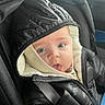 Tiago participe au concours pour gagner de l'argent avec cette photo : baby, child, infant, car_seat, jacket, hood, blue_eyes, cute, expression, tongue, warm_clothing, seatbelt, portrait, indoor, car_interior, person, young_child, winter_wear, closeup, face