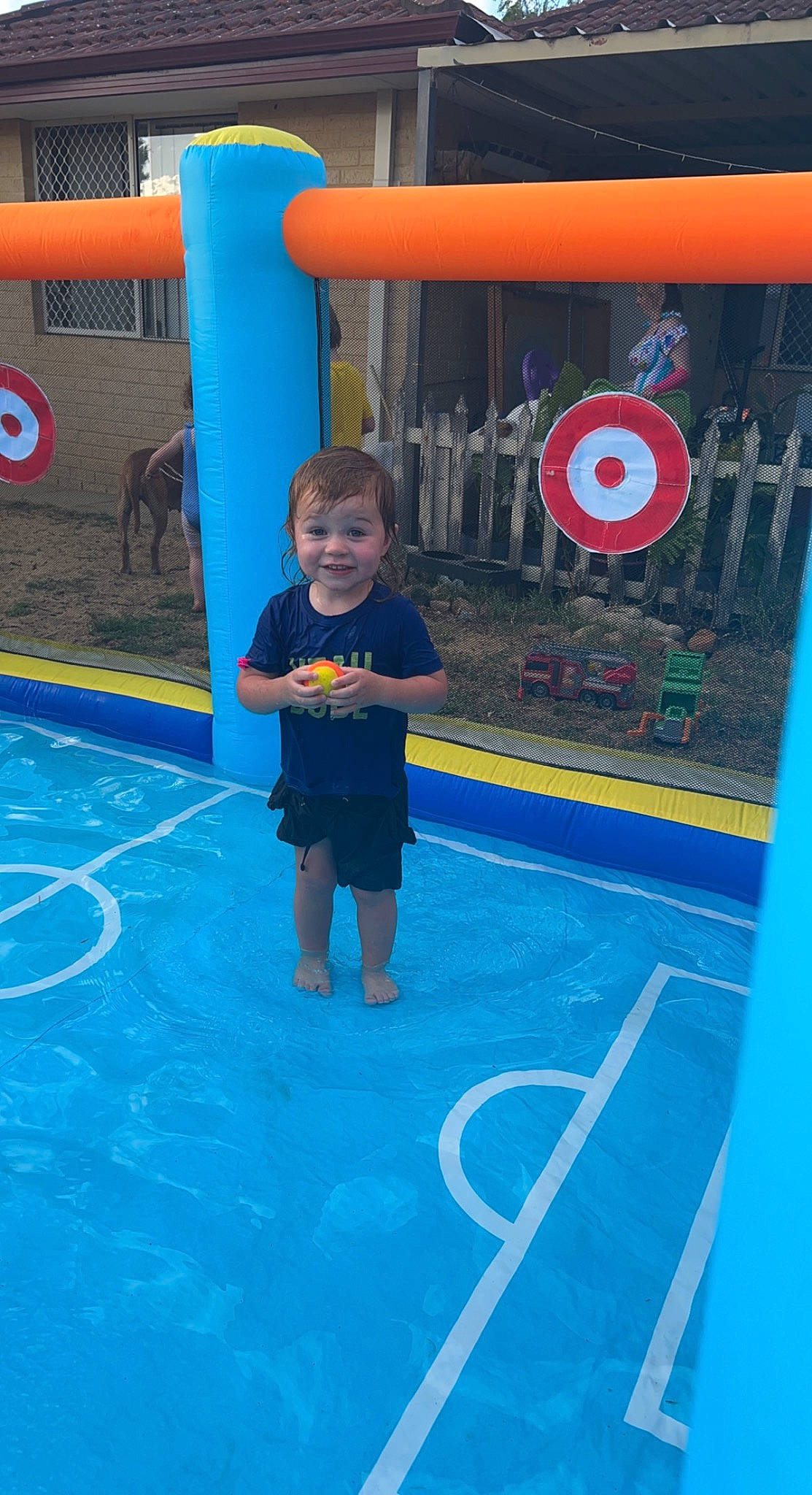 Louis is registered to the contest to win money with this photo: active_shorts, baby_toddler_clothing, child, city, electric_blue, flooring, fun, human_settlement, joy, leisure, logo, person, play, playground, recreation, shorts, smile, sports, t_shirt, team_sport