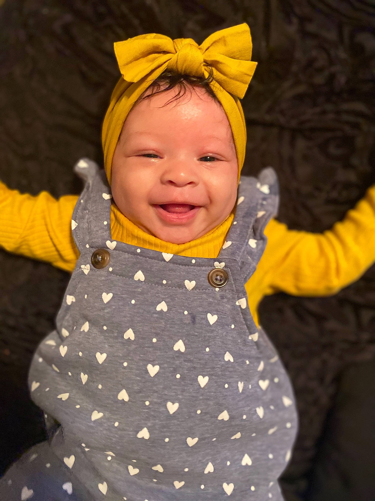 Treasure is registered to the contest to win money with this photo: baby, child, design, ear, fun, head, headgear, outerwear, pattern, person, smile, toddler, yellow