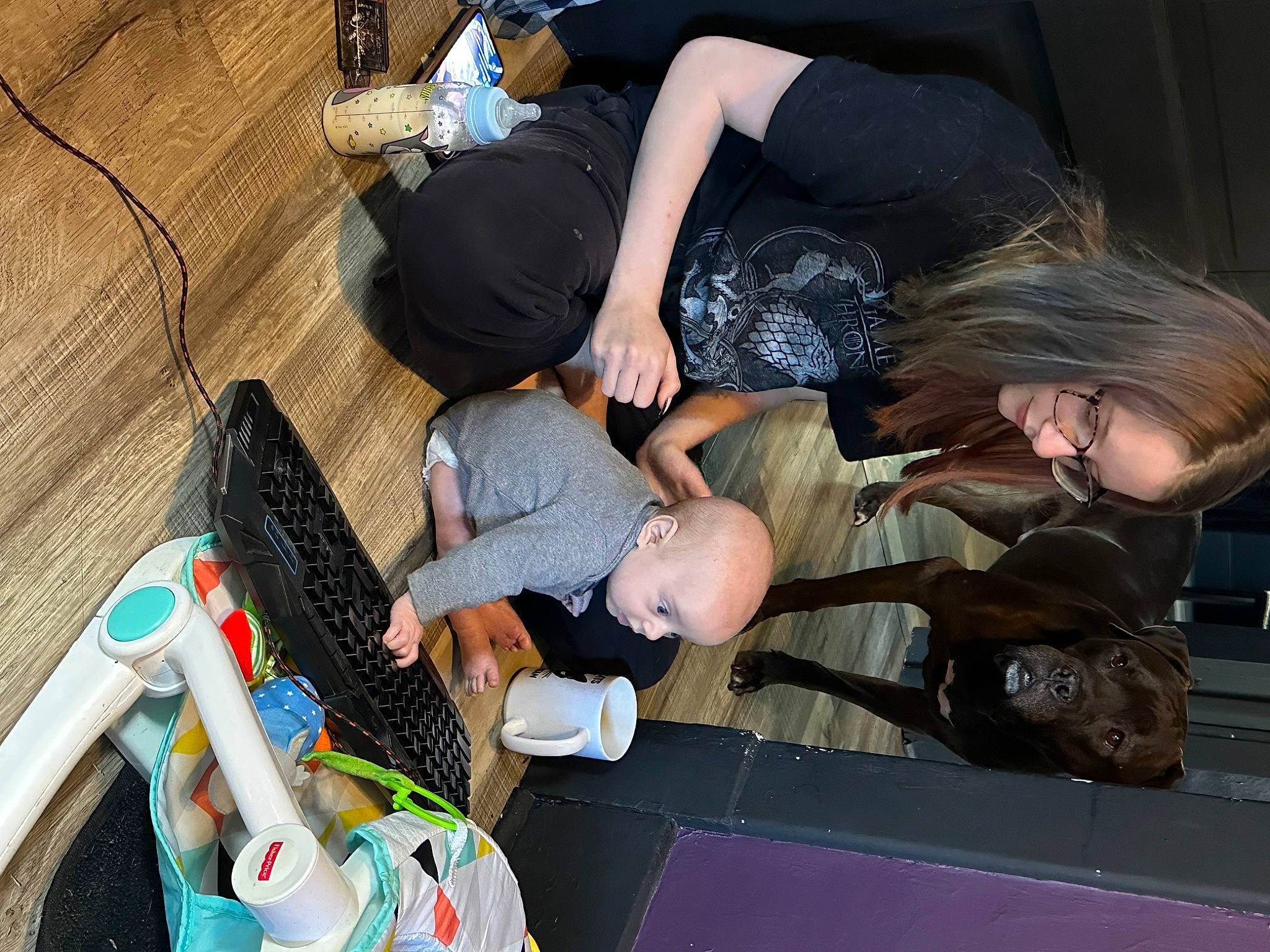 Zavier is registered to the contest to win money with this photo: arm, bag, event, flooring, fun, hat, human_leg, joint, lap, leisure, luggage_and_bags, person, plastic, recreation, room, shoe, sitting, sneakers, t_shirt, thigh