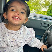 Eliannie joined the competition — help win amazing prizes! car, child, clothing, cute, face, greenery, happy, headband, indoors, interior, nature, person, portrait, seat, smiling, steering_wheel, sweater, toddler, window, young