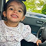 car, child, clothing, cute, face, greenery, happy, headband, indoors, interior, nature, person, portrait, seat, smiling, steering_wheel, sweater, toddler, window, young