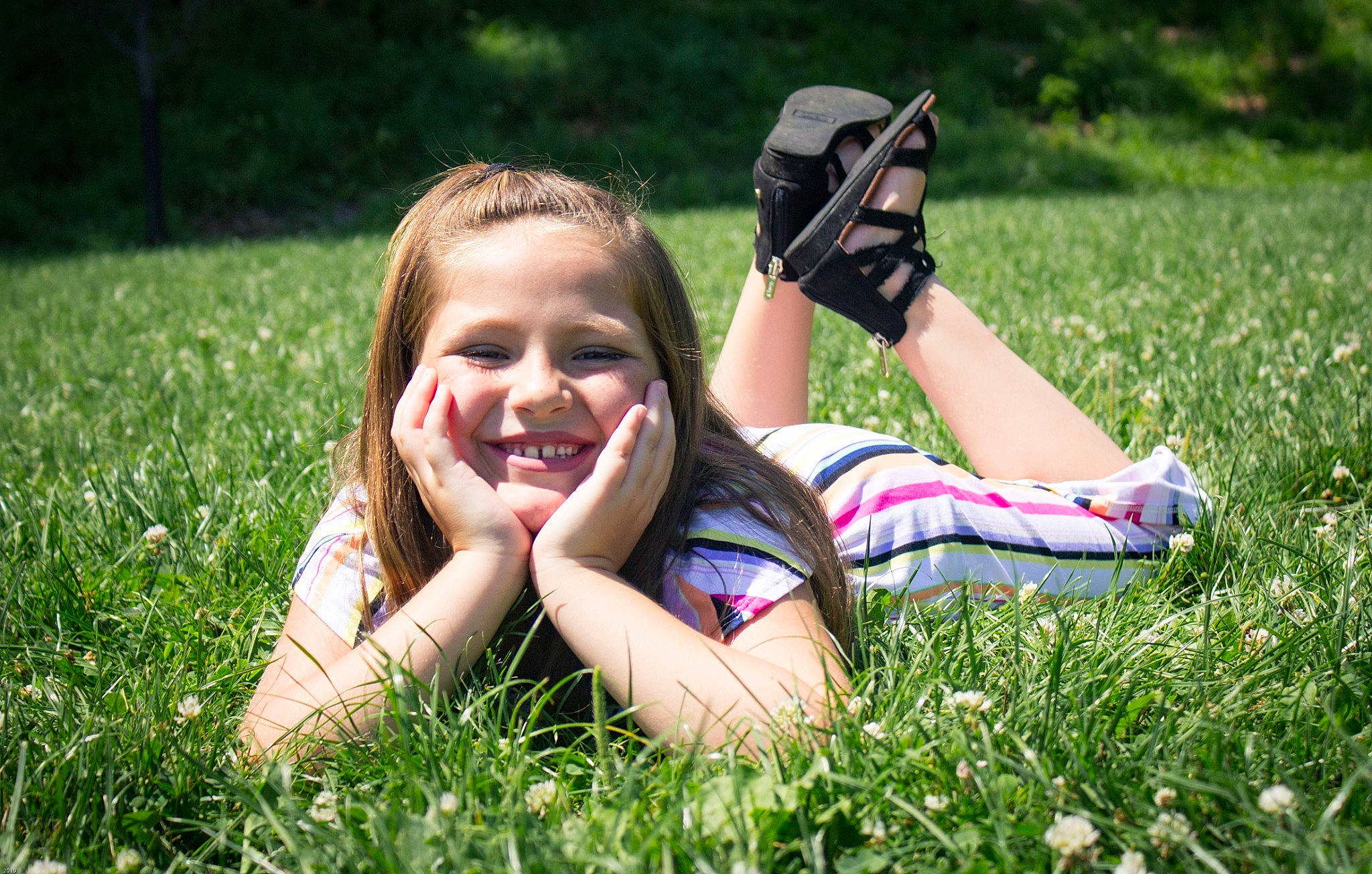 Brielle is registered to the contest to win money with this photo: beauty, blond, child, facial_expression, fun, grass, grass_family, grassland, green, happy, joy, lawn, leaf, meadow, people_in_nature, person, photograph, plant, sitting, smile