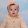 baby, infant, headband, bow, peach_color, button_up_shirt, long_sleeves, curious_expression, wide_eyes, portrait, studio_background, clouds, soft_lighting, child, cute, fashion, sitting, young_child, face, person