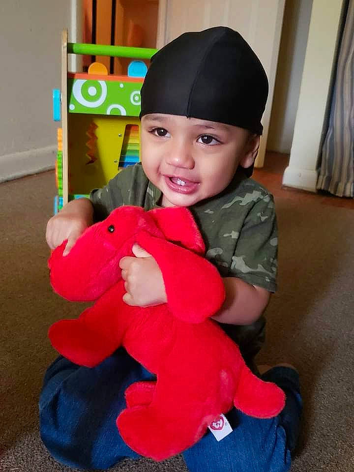 Lee is registered to the contest to win money with this photo: baby_toddler_clothing, cap, carmine, child, costume_hat, event, face, fun, happy, hat, head, headwear, holiday, joy, lap, magenta, party_supply, person, pink, sleeve