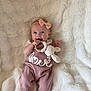 Gracie joined the competition — help win amazing prizes! baby, infant, smiling, pink_outfit, headband, bow, teether, crocheted_toy, bunny_toy, blanket, soft_texture, cute, happy, child, lying_down, knitted_clothing, footwear_free, indoors, portrait, playful