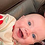 Gracie joined the competition — help win amazing prizes! baby, smiling, happy, face, blue_eyes, hoodie, red_pattern, cream_clothing, leather_couch, infant, close_up, child, person, portrait, indoors, cute, joyful, skin, head, expression