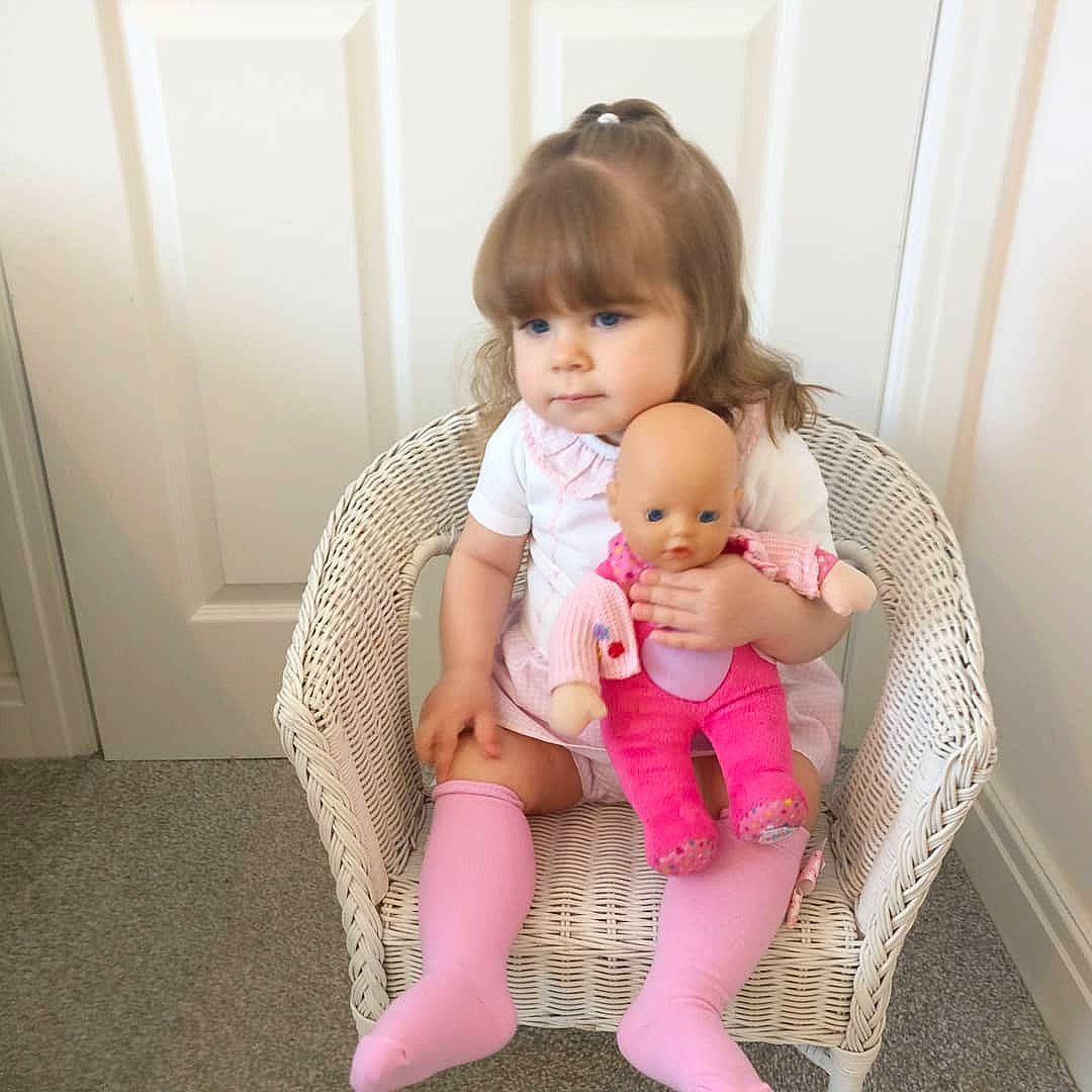 Beaux is registered to the contest to win money with this photo: baby, baby_toddler_clothing, beauty, cheek, child, daughter, dress, finger, human, human_leg, joint, knee, leg, person, pink, product, sitting, skin, thigh, tights