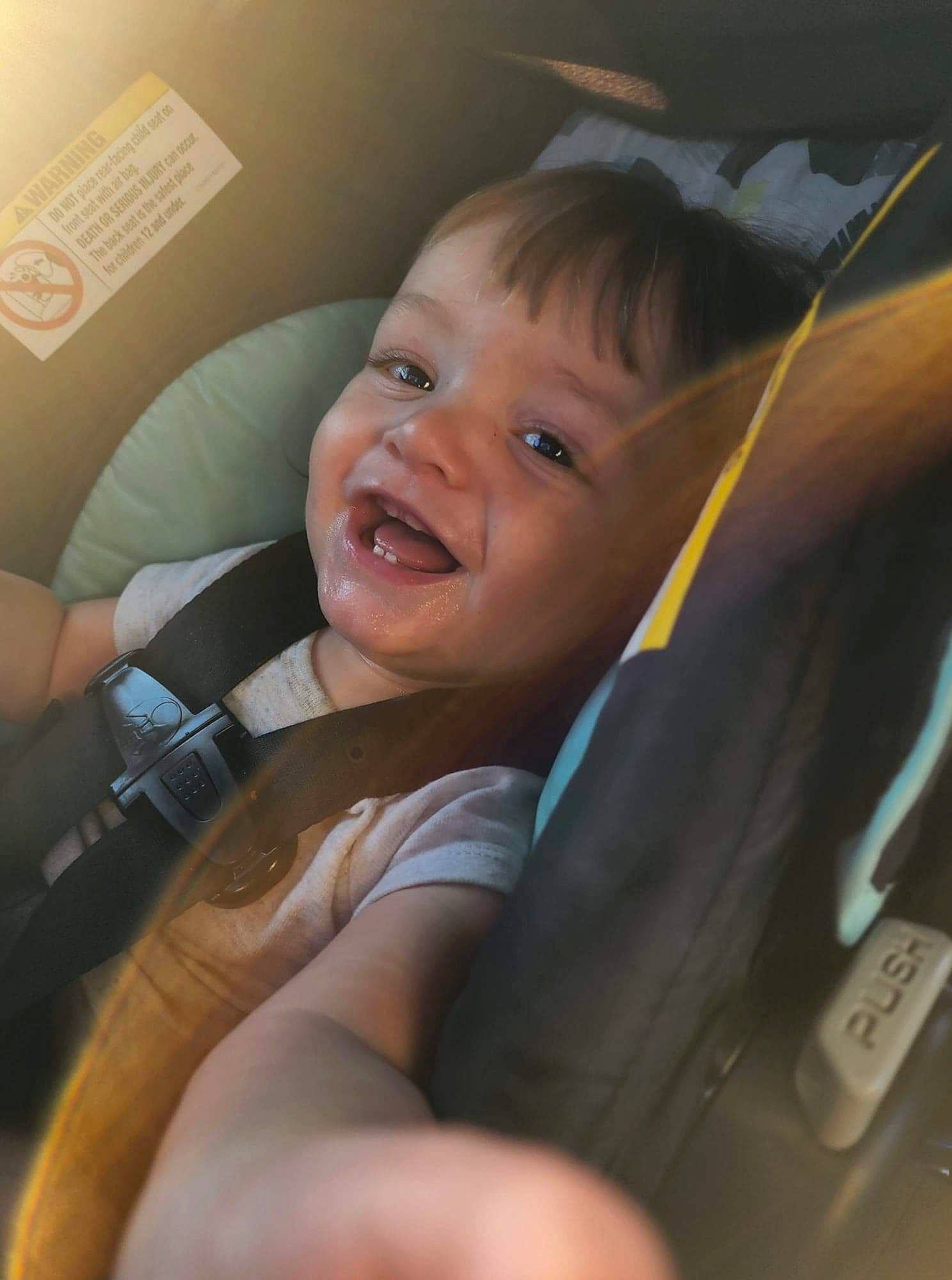 Klayson is registered to the contest to win money with this photo: baby, baby_products, car_seat, cheek, chest, comfort, eyebrow, finger, gesture, happy, iris, mouth, nose, person, seat_belt, skin, smile, thumb, toddler, vehicle_door