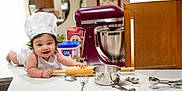 Lukah joined the competition — help win amazing prizes! apron, baby, baking, chef_hat, child, cooking, countertop, cute, flour, food_preparation, happy, indoor, kitchen, measuring_spoons, mixing_bowl, playful, rolling_pin, smile, utensils, whisk